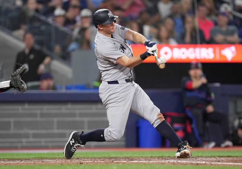 Jun 28, 2024; Toronto, Ontario, CAN; New York Yankees third baseman DJ LeMahieu (26) hits a double against the Toronto Blue Jays during the eighth inning at Rogers Centre. Mandatory Credit: Nick Turchiaro-USA TODAY Sports