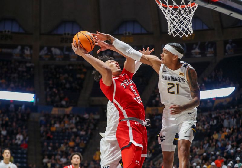 Mar 2, 2024; Morgantown, West Virginia, USA; Texas Tech Red Raiders guard Darrion Williams (5) shoots in the lane against West Virginia Mountaineers guard RaeQuan Battle (21) during the first half at WVU Coliseum. Mandatory Credit: Ben Queen-USA TODAY Sports