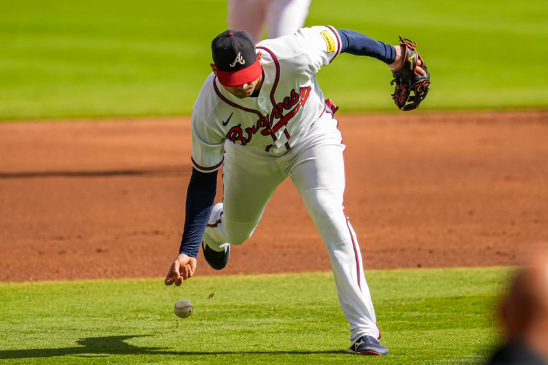 Oct 1, 2023; Cumberland, Georgia, USA; Atlanta Braves third baseman Austin Riley (27) can   t field a ball hit by left fielder Alex Call (17) (not shown) during the first inning at Truist Park. Mandatory Credit: Dale Zanine-USA TODAY Sports