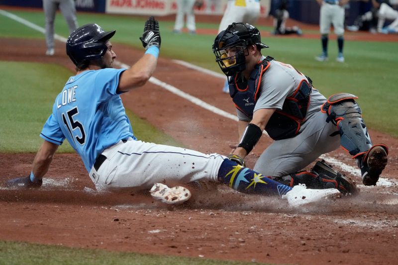 Apr 2, 2023; St. Petersburg, Florida, USA; Tampa Bay Rays right fielder Josh Lowe (15) slides in to home and is tagged out by Detroit Tigers catcher Jake Rogers (34) during the eighth inning at Tropicana Field. Mandatory Credit: Dave Nelson-USA TODAY Sports