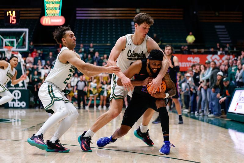 Feb 15, 2023; Fort Collins, Colorado, USA; Boise State Broncos forward Naje Smith (23) controls the ball as he is fouled by Colorado State Rams forward Patrick Cartier (12) as guard Isaiah Rivera (23) defends in the second half at Moby Arena. Mandatory Credit: Isaiah J. Downing-USA TODAY Sports