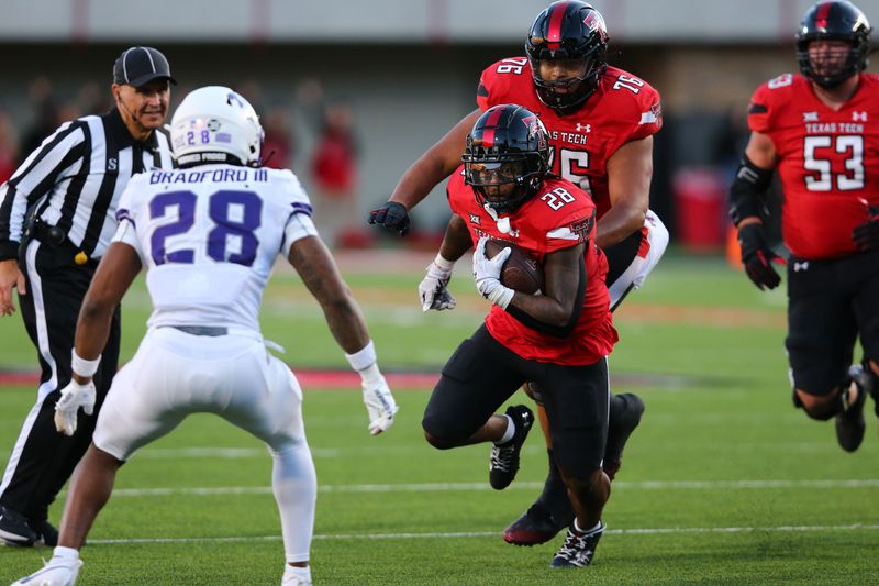 Nov 2, 2023; Lubbock, Texas, USA; Texas Tech Red Raiders running back Tahj Brooks (28) rushes against Texas Christian Horned Frogs defensive back Millard Bradford (28) in the first half at Jones AT&T Stadium and Cody Campbell Field. Mandatory Credit: Michael C. Johnson-USA TODAY Sports