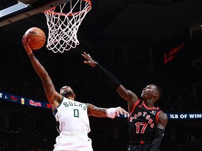 TORONTO, CANADA - NOVEMBER 15:  Damian Lillard #0 of the Milwaukee Bucks drives to the basket as Dennis Schroder #17 of the Toronto Raptors plays defense during the game on November 15, 2023 at the Scotiabank Arena in Toronto, Ontario, Canada.  NOTE TO USER: User expressly acknowledges and agrees that, by downloading and or using this Photograph, user is consenting to the terms and conditions of the Getty Images License Agreement.  Mandatory Copyright Notice: Copyright 2023 NBAE (Photo by Vaughn Ridley/NBAE via Getty Images)