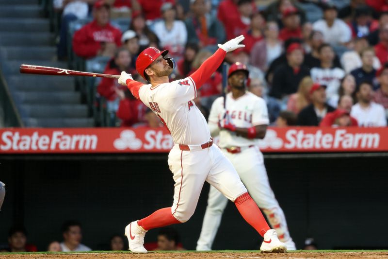 May 23, 2025; Anaheim, California, USA;  Los Angeles Angels left fielder Taylor Ward (3) hits a sacrifice fly during the fourth inning against the Miami Marlins at Angel Stadium. Mandatory Credit: Kiyoshi Mio-Imagn Images