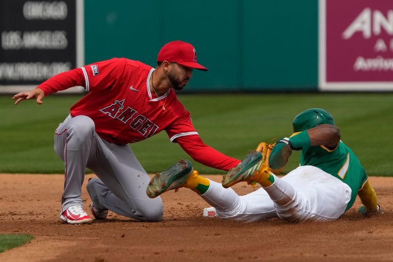 Mar 23, 2024; Mesa, Arizona, USA; Los Angeles Angels second baseman Livan Soto (73) tags out Oakland Athletics center fielder Esteury Ruiz (1) trying to steal in the second inning at Hohokam Stadium. Mandatory Credit: Rick Scuteri-USA TODAY Sports