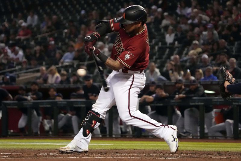 Mar 27, 2023; Phoenix, Arizona, USA; Arizona Diamondbacks catcher Jose Herrera (11) bats against the Cleveland Guardians during the third inning at Chase Field. Mandatory Credit: Joe Camporeale-USA TODAY Sports