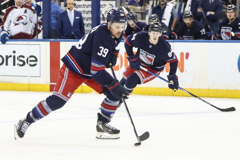 Jan 26, 2025; New York, New York, USA; New York Rangers center Sam Carrick (39) controls the puck in the second period against the Colorado Avalanche at Madison Square Garden. Mandatory Credit: Wendell Cruz-Imagn Images