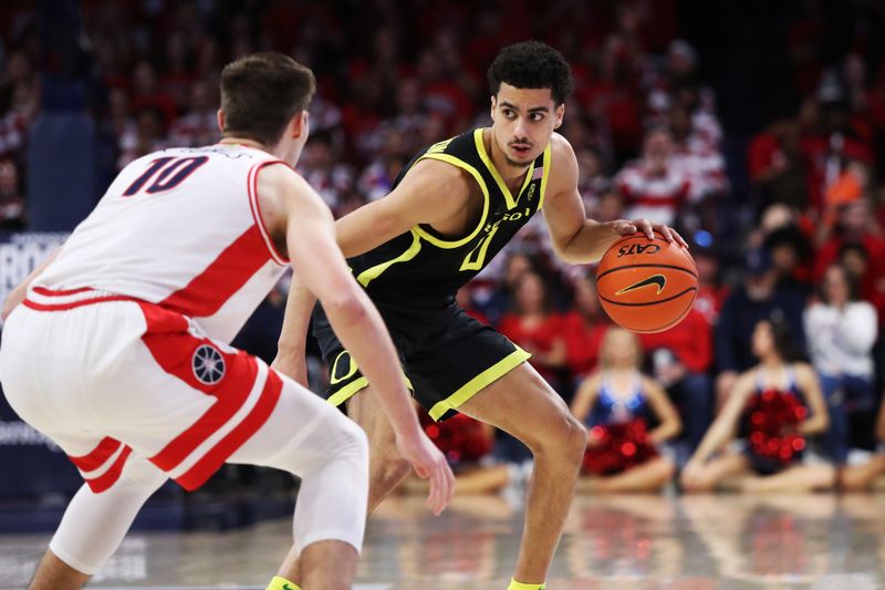 Feb 2, 2023; Tucson, Arizona, USA; Oregon Ducks guard Will Richardson (0) drives to the net against Arizona Wildcats forward Azuolas Tubelis (10) in the first half at McKale Center. Mandatory Credit: Zachary BonDurant-USA TODAY Sports