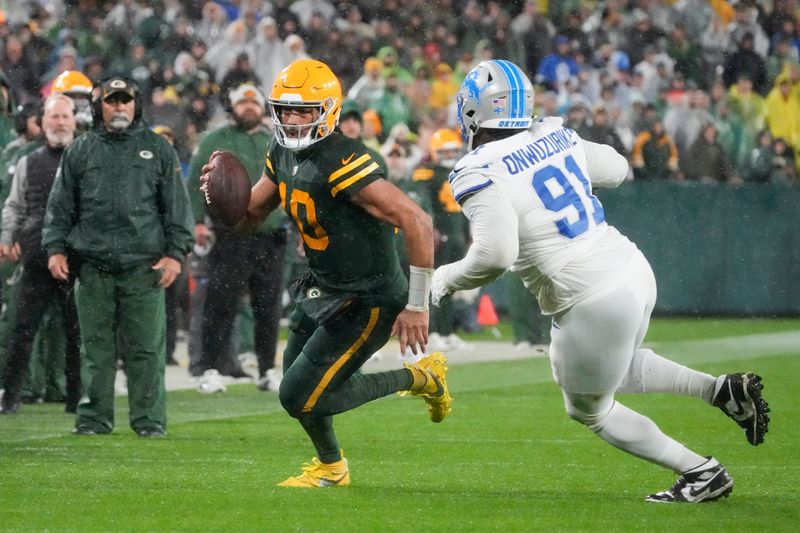 Green Bay Packers quarterback Jordan Love (10) is chased by Detroit Lions defensive end Levi Onwuzurike (91) during the second half of an NFL football game Sunday, Nov. 3, 2024, in Green Bay, Wis. (AP Photo/Morry Gash)