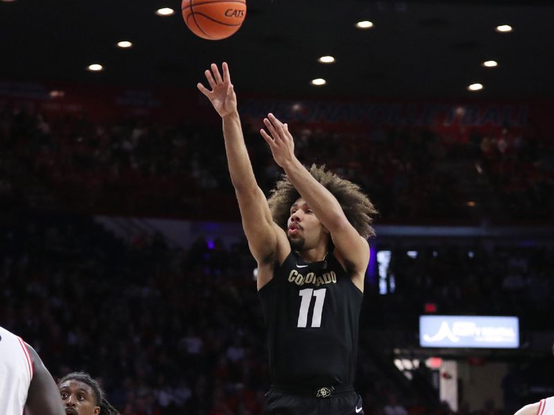 Feb 18, 2023; Tucson, Arizona, USA; Colorado Buffaloes guard Javon Ruffin (11) makes a basket against Arizona Wildcats guard Cedric Henderson Jr. (45) during the first half at McKale Center. Mandatory Credit: Zachary BonDurant-USA TODAY Sports