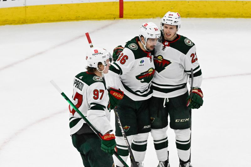 Apr 7, 2024; Chicago, Illinois, USA;  Minnesota Wild center Marco Rossi (23) celebrates his goal against the Chicago Blackhawks with  right wing Mats Zuccarello (36) and left wing Kirill Kaprizov (97)  during the second period at United Center. Mandatory Credit: Matt Marton-USA TODAY Sports