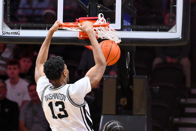 Jan 17, 2026; Nashville, Tennessee, USA;  Vanderbilt Commodores forward Jalen Washington (13) dunks the ball against the Florida Gators during the first half at Memorial Gymnasium. Mandatory Credit: Steve Roberts-Imagn Images