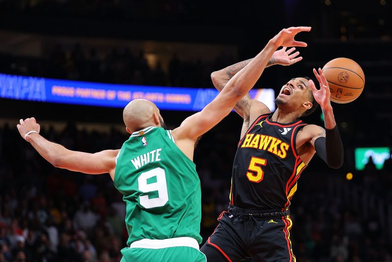 ATLANTA, GEORGIA - MARCH 28:  Derrick White #9 of the Boston Celtics knocks the ball away from Dejounte Murray #5 of the Atlanta Hawks during overtime at State Farm Arena on March 28, 2024 in Atlanta, Georgia.  NOTE TO USER: User expressly acknowledges and agrees that, by downloading and/or using this photograph, user is consenting to the terms and conditions of the Getty Images License Agreement.  (Photo by Kevin C. Cox/Getty Images)