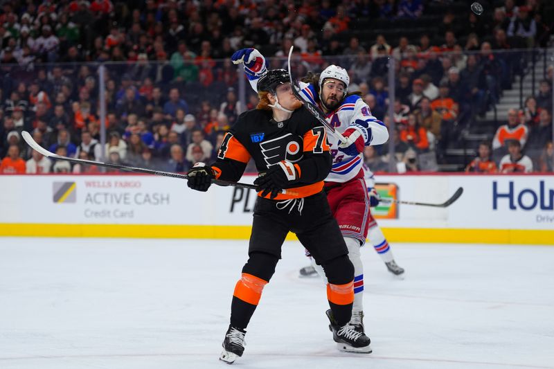 Nov 29, 2024; Philadelphia, Pennsylvania, USA; Philadelphia Flyers right wing Owen Tippett (74) and New York Rangers center Mika Zibanejad (93) battle for a loose puck in the first period at Wells Fargo Center. Mandatory Credit: Kyle Ross-Imagn Images