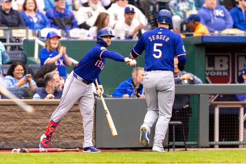 May 4, 2024; Kansas City, Missouri, USA; Texas Rangers shortstop Corey Seager (5) fist bumps Texas Rangers first base Nathaniel Lowe (30) after scoring during the first inning against the Kansas City Royals at Kauffman Stadium. Mandatory Credit: William Purnell-USA TODAY Sports