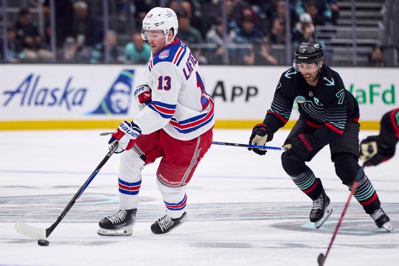 Nov 1, 2025; Seattle, Washington, USA; New York Rangers left wing Alexis Lafrenière (13) skates with the puck as Seattle Kraken right wing Jordan Eberle (7) defends during the second period at Climate Pledge Arena. Mandatory Credit: Blake Dahlin-Imagn Images