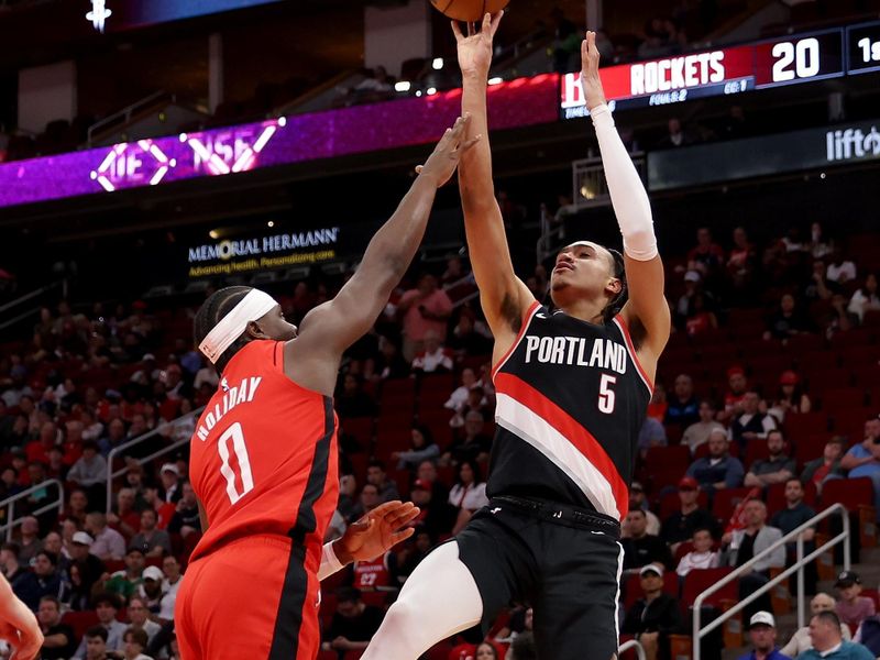 HOUSTON, TEXAS - MARCH 25: Dalano Banton #5 of the Portland Trail Blazers shoots against Aaron Holiday #0 of the Houston Rockets in the first half at Toyota Center on March 25, 2024 in Houston, Texas.  NOTE TO USER: User expressly acknowledges and agrees that, by downloading and or using this photograph, User is consenting to the terms and conditions of the Getty Images License Agreement. (Photo by Tim Warner/Getty Images)