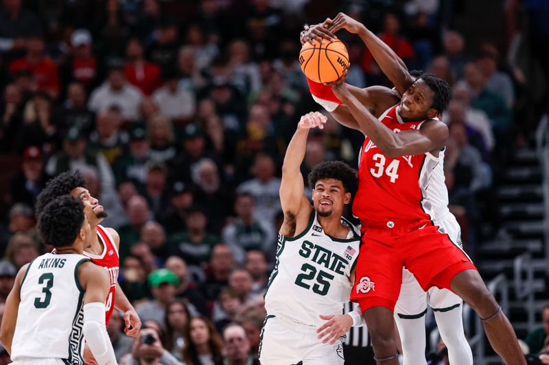 Mar 10, 2023; Chicago, IL, USA; Ohio State Buckeyes center Felix Okpara (34) grabs a rebound against Michigan State Spartans forward Malik Hall (25) during the second half at United Center. Mandatory Credit: Kamil Krzaczynski-USA TODAY Sports