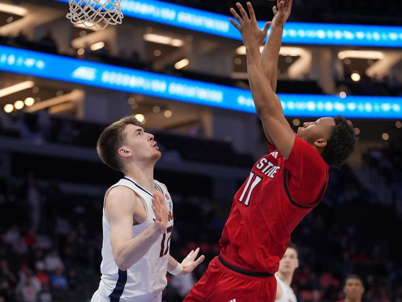 Mar 12, 2026; Charlotte, NC, USA; NC State Wolfpack guard Quadir Copeland (11) shoots the ball defended by Virginia Cavaliers center Johann Grünloh (17) during the second half at Spectrum Center. Mandatory Credit: Jim Dedmon-Imagn Images Mar 12, 2026; Charlotte, NC, USA; NC State Wolfpack guard Quadir Copeland (11) shoots the ball defended by Virginia Cavaliers center Johann Grünloh (17) during the second half at Spectrum Center. Mandatory Credit: Jim Dedmon-Imagn Images