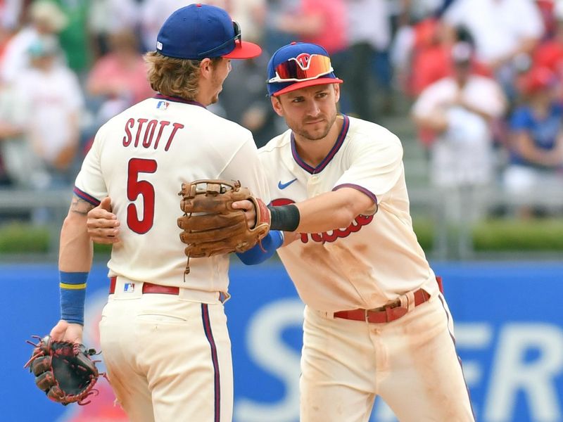 Jun 11, 2023; Philadelphia, Pennsylvania, USA; Philadelphia Phillies second baseman Bryson Stott (5) and  shortstop Trea Turner (7) celebrate win against the Los Angeles Dodgers at Citizens Bank Park. Mandatory Credit: Eric Hartline-USA TODAY Sports