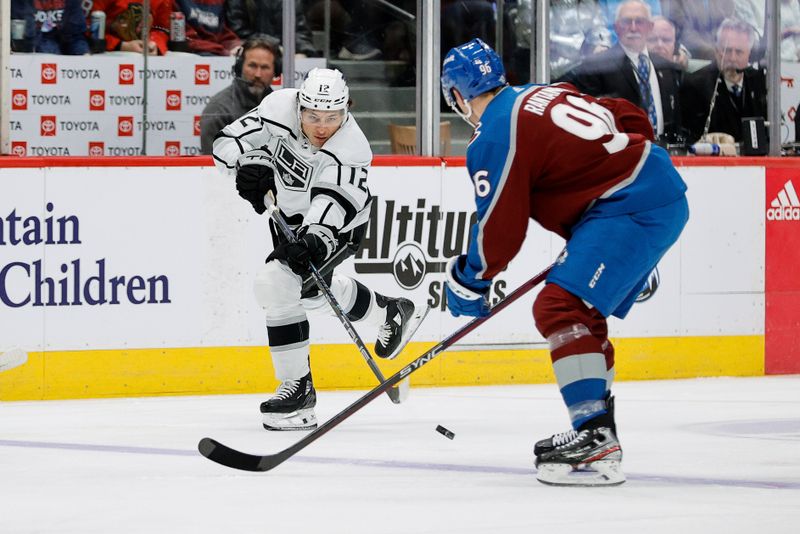 Jan 26, 2024; Denver, Colorado, USA; Los Angeles Kings left wing Trevor Moore (12) passes the puck as Colorado Avalanche right wing Mikko Rantanen (96) defends in the first period at Ball Arena. Mandatory Credit: Isaiah J. Downing-USA TODAY Sports