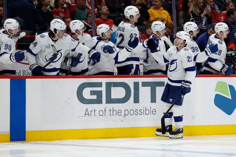 Oct 14, 2025; Washington, District of Columbia, USA; Tampa Bay Lightning center Brayden Point (21) celebrates with teammates after scoring a goal against the Washington Capitals in the third period at Capital One Arena. Mandatory Credit: Geoff Burke-Imagn Images