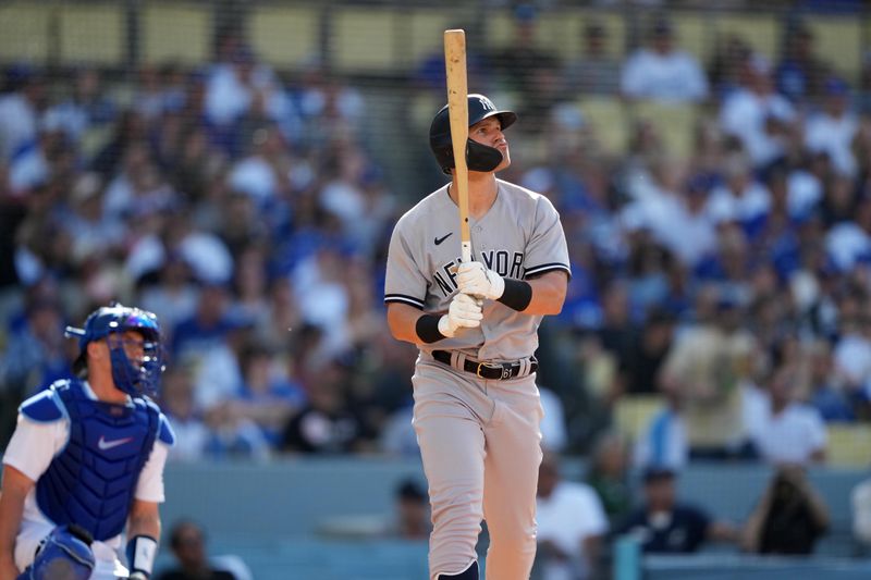 Jun 3, 2023; Los Angeles, California, USA; New York Yankees left fielder Jake Bauers (61) follows through on a home run in the fourth inning as Los Angeles Dodgers catcher Will Smith (16) and home plate umpire John Tumpane (74) watch at Dodger Stadium. Mandatory Credit: Kirby Lee-USA TODAY Sports