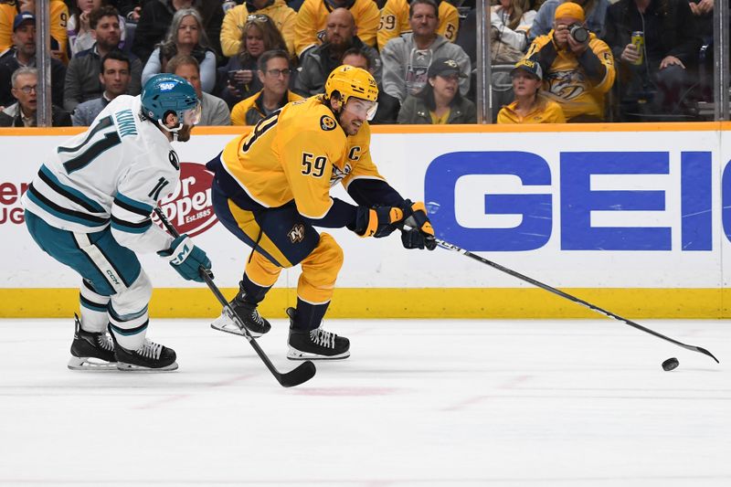 Mar 19, 2024; Nashville, Tennessee, USA; Nashville Predators defenseman Roman Josi (59) controls the puck against San Jose Sharks center Luke Kunin (11) during the third period at Bridgestone Arena. Mandatory Credit: Christopher Hanewinckel-USA TODAY Sports