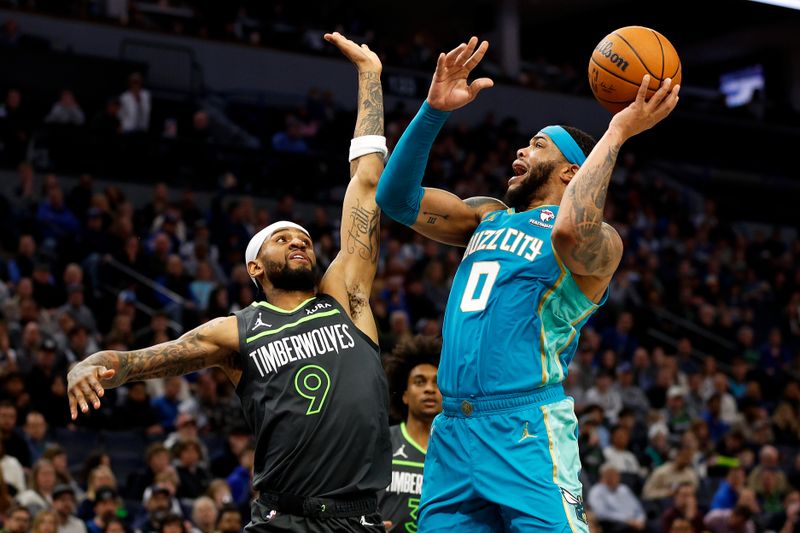 MINNEAPOLIS, MINNESOTA - JANUARY 22: Miles Bridges #0 of the Charlotte Hornets goes up for a shot against Nickeil Alexander-Walker #9 of the Minnesota Timberwolves in the third quarter at Target Center on January 22, 2024 in Minneapolis, Minnesota. The Hornets won 128-125. NOTE TO USER: User expressly acknowledges and agrees that, by downloading and or using this photograph, User is consenting to the terms and conditions of the Getty Images License Agreement. (Photo by David Berding/Getty Images)