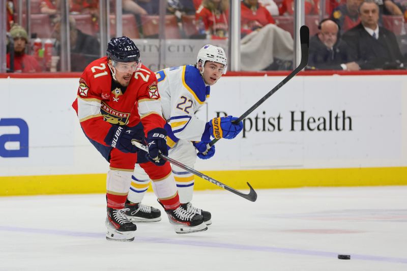 Apr 13, 2024; Sunrise, Florida, USA; Florida Panthers center Nick Cousins (21) and Buffalo Sabres right wing Jack Quinn (22) battle for the puck during the first period at Amerant Bank Arena. Mandatory Credit: Sam Navarro-USA TODAY Sports