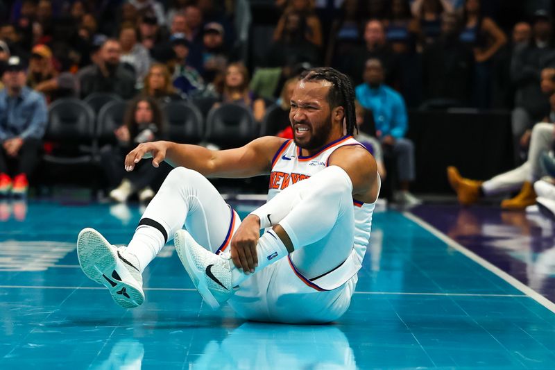 CHARLOTTE, NORTH CAROLINA - NOVEMBER 29: Jalen Brunson #11 of the New York Knicks holds his ankle after a fall during the second half of a basketball game against the Charlotte Hornets at Spectrum Center on November 29, 2024 in Charlotte, North Carolina. NOTE TO USER: User expressly acknowledges and agrees that, by downloading and or using this photograph, User is consenting to the terms and conditions of the Getty Images License Agreement. (Photo by David Jensen/Getty Images)