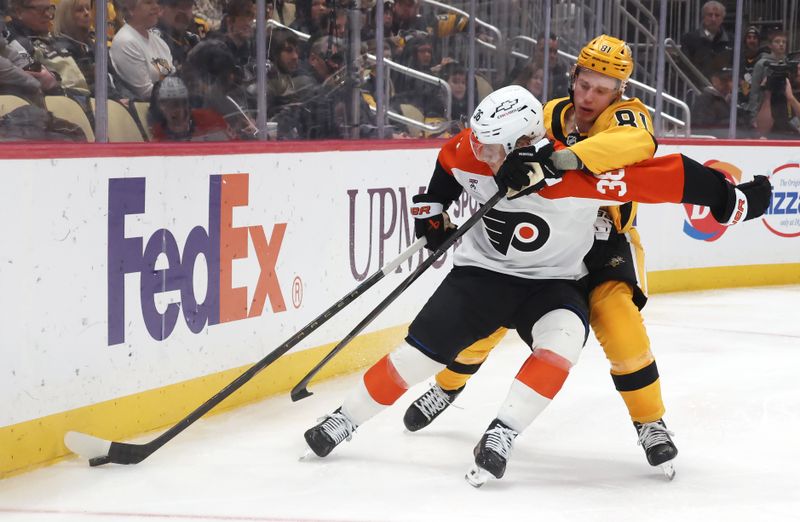 Jan 15, 2026; Pittsburgh, Pennsylvania, USA;  Philadelphia Flyers defenseman Emil Andrae (36) moves the puck against pressure from Pittsburgh Penguins center Ben Kindel (81) during the third period at PPG Paints Arena. Mandatory Credit: Charles LeClaire-Imagn Images