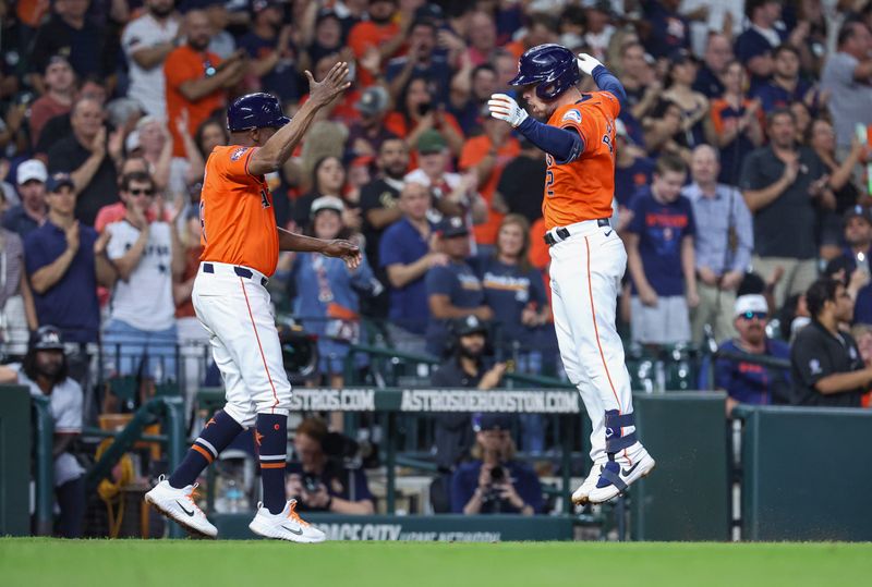 May 31, 2024; Houston, Texas, USA; Houston Astros third baseman Alex Bregman (2) leaps after rounding third base on a home run during the fourth inning against the Minnesota Twins at Minute Maid Park. Mandatory Credit: Troy Taormina-USA TODAY Sports