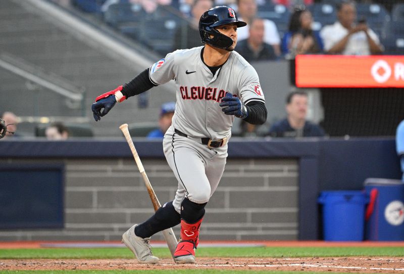 Jun 14, 2024; Toronto, Ontario, CAN;  Cleveland Indians second baseman Andres Gimenez (0) hits an RBI single against the Toronto Blue Jays in the fifth inning at Rogers Centre. Mandatory Credit: Dan Hamilton-USA TODAY Sports