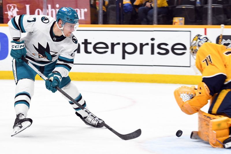 Mar 19, 2024; Nashville, Tennessee, USA; San Jose Sharks center Nico Sturm (7) has a shot stopped by Nashville Predators goaltender Juuse Saros (74) during the second period at Bridgestone Arena. Mandatory Credit: Christopher Hanewinckel-USA TODAY Sports