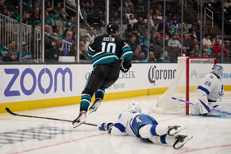 Mar 21, 2024; San Jose, California, USA; San Jose Sharks center Klim Kostin (10) leaps over the stick of Tampa Bay Lightning defenseman Emil Martinsen Lilleberg (78) during the second period at SAP Center at San Jose. Mandatory Credit: Robert Edwards-USA TODAY Sports