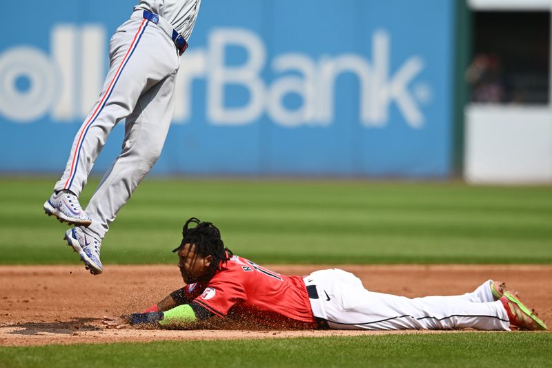 Aug 25, 2024; Cleveland, Ohio, USA; Cleveland Guardians third baseman Jose Ramirez (11) steals second base under exas Rangers second baseman Marcus Semien (2) during the third inning at Progressive Field. Mandatory Credit: Ken Blaze-USA TODAY Sports