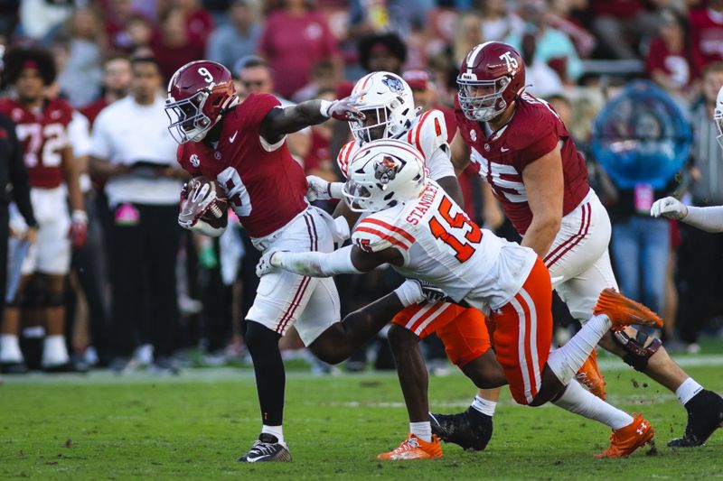 Nov 16, 2024; Tuscaloosa, Alabama, USA; Mercer Bears linebacker Ken Standley (15) grabs onto Alabama Crimson Tide running back Richard Young (9) during the third quarter at Bryant-Denny Stadium. Mandatory Credit: Will McLelland-Imagn Images