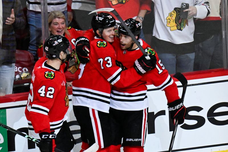 Oct 19, 2024; Chicago, Illinois, USA;  Chicago Blackhawks left wing Lukas Reichel (73) celebrates after assisting  center Craig Smith (15) with a goal during the second period against the Buffalo Sabres at the United Center. Mandatory Credit: Matt Marton-Imagn Images