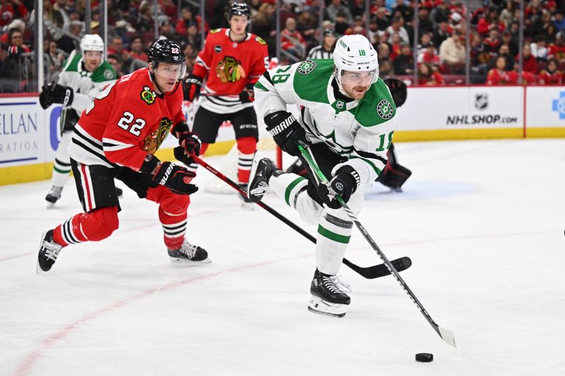 Jan 13, 2024; Chicago, Illinois, USA;  Dallas Stars forward Sam Steel (18) controls the puck while being defended by Chicago Blackhawks defenseman Nikita Zaitsev (22) in the second period at United Center. Mandatory Credit: Jamie Sabau-USA TODAY Sports