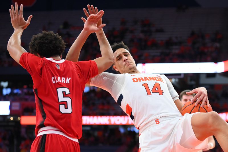 Feb 14, 2023; Syracuse, New York, USA; North Carolina State Wolfpack guard Jack Clark (5) and Syracuse Orange center Jesse Edwards (14) get tangled up while battling for a rebound during the second half at the JMA Wireless Dome. Mandatory Credit: Rich Barnes-USA TODAY Sports