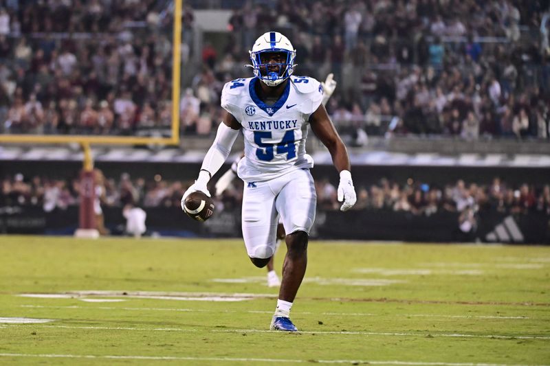 Nov 4, 2023; Starkville, Mississippi, USA; Kentucky Wildcats linebacker D'Eryk Jackson (54) runs the ball after an interception against the Mississippi State Bulldogs during the second quarter at Davis Wade Stadium at Scott Field. Mandatory Credit: Matt Bush-USA TODAY Sports