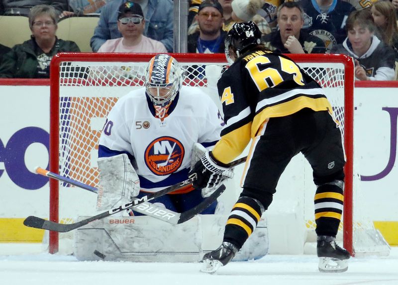 Mar 9, 2023; Pittsburgh, Pennsylvania, USA;  New York Islanders goaltender Ilya Sorokin (30) makes a save against Pittsburgh Penguins center Mikael Granlund (64) during the second period at PPG Paints Arena. Mandatory Credit: Charles LeClaire-USA TODAY Sports