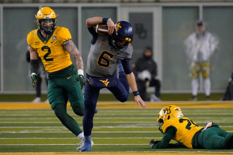 Nov 25, 2023; Waco, Texas, USA; West Virginia Mountaineers quarterback Garrett Greene (6) is tripped up by  Baylor Bears safety Devyn Bobby (28) during the first half at McLane Stadium. Mandatory Credit: Raymond Carlin III-USA TODAY Sports