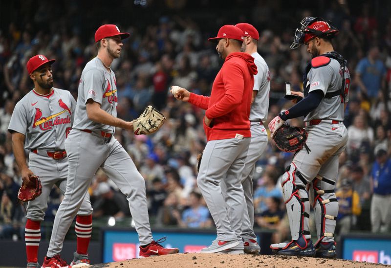 May 10, 2024; Milwaukee, Wisconsin, USA; St. Louis Cardinals manager Oliver Marmol (37) hands the ball to St. Louis Cardinals pitcher Matthew Liberatore (52) in the fifth inning against the Milwaukee Brewers at American Family Field. Mandatory Credit: Michael McLoone-USA TODAY Sports