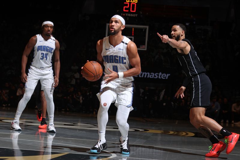 BROOKLYN, NY - NOVEMBER 29: Jalen Suggs #4 of the Orlando Magic dribbles the ball during the game against the Brooklyn Nets during a Emirates NBA Cup game on October 22, 2024 at Barclays Center in Brooklyn, New York. NOTE TO USER: User expressly acknowledges and agrees that, by downloading and or using this Photograph, user is consenting to the terms and conditions of the Getty Images License Agreement. Mandatory Copyright Notice: Copyright 2024 NBAE (Photo by Nathaniel S. Butler/NBAE via Getty Images)