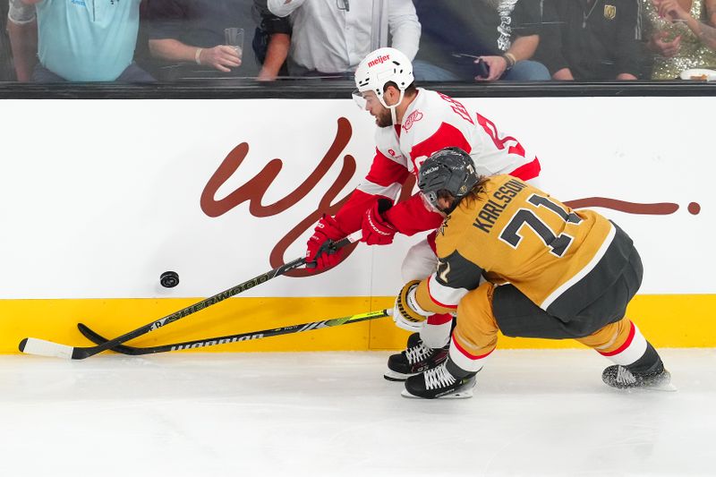 Nov 4, 2025; Las Vegas, Nevada, USA; Vegas Golden Knights center William Karlsson (71) tips the puck away from Detroit Red Wings right wing Alex Debrincat (93) during the third period at T-Mobile Arena. Mandatory Credit: Stephen R. Sylvanie-Imagn Images