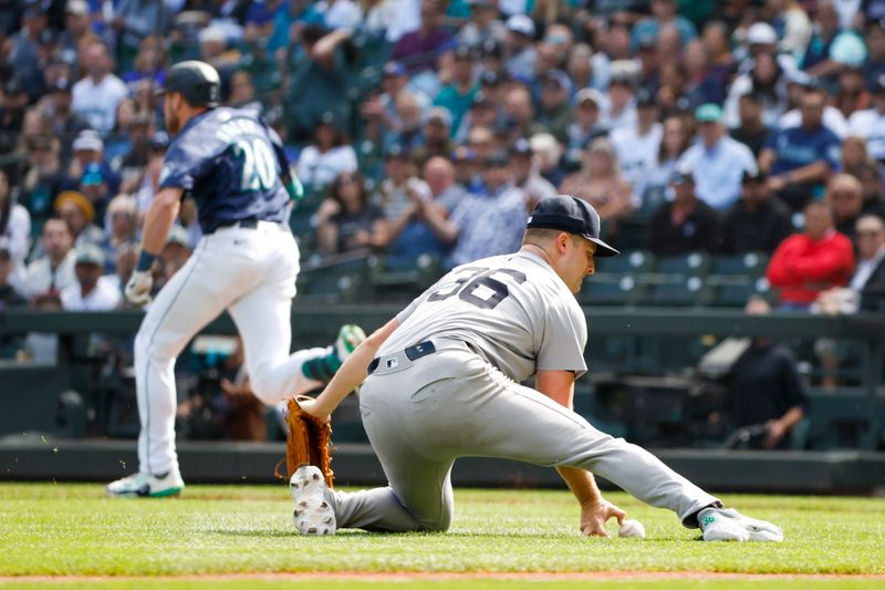 Sep 19, 2024; Seattle, Washington, USA; New York Yankees starting pitcher Clarke Schmidt (36) fields a bunt single by Seattle Mariners right fielder Luke Raley (20, background) during the first inning at T-Mobile Park. Mandatory Credit: Joe Nicholson-Imagn Images