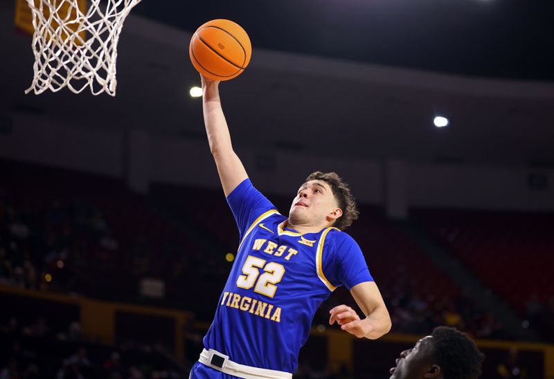 Jan 21, 2026; Tempe, Arizona, USA; West Virginia Mountaineers forward Treysen Eaglestaff (52) dunks the ball against the Arizona State Sun Devils in the first half at Desert Financial Arena. Mandatory Credit: Mark J. Rebilas-Imagn Images
