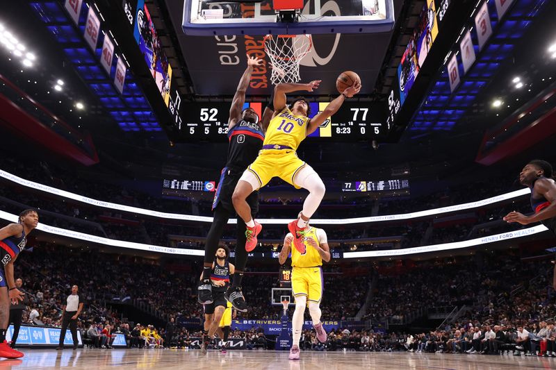 DETROIT, MICHIGAN - NOVEMBER 29: Max Christie #10 of the Los Angeles Lakers drives to the basket against Jalen Duren #0 of the Detroit Pistons during the second half at Little Caesars Arena on November 29, 2023 in Detroit, Michigan. The Los Angeles Lakers won the game 133-107. NOTE TO USER: User expressly acknowledges and agrees that, by downloading and or using this photograph, User is consenting to the terms and conditions of the Getty Images License Agreement. (Photo by Gregory Shamus/Getty Images)